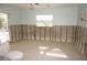Bathroom awaiting renovations featuring exposed block wall, toilet, and sliding glass door at 285 Bal Harbor Blvd, Punta Gorda, FL 33950