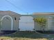 Decorative gate in archway leads to courtyard with exterior wall and lush landscaping at 285 Bal Harbor Blvd, Punta Gorda, FL 33950
