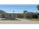 Inviting single-story home with a well-manicured front yard featuring lush landscaping and a concrete driveway at 285 Bal Harbor Blvd, Punta Gorda, FL 33950