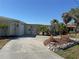 Charming single-story home with a concrete driveway and decorative rock landscaping in the front yard at 285 Bal Harbor Blvd, Punta Gorda, FL 33950