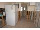 View of an unfinished kitchen with exposed framing, leading to the bathroom at 285 Bal Harbor Blvd, Punta Gorda, FL 33950