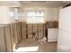 Unfinished kitchen with exposed framing, new appliances, and a window overlooking the backyard at 285 Bal Harbor Blvd, Punta Gorda, FL 33950