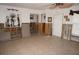 Living room with tile flooring, a ceiling fan, and decorative items on shelves at 285 Bal Harbor Blvd, Punta Gorda, FL 33950