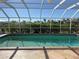 Sparkling pool with a screened enclosure, offering a private oasis for relaxation and recreation at 285 Bal Harbor Blvd, Punta Gorda, FL 33950