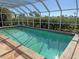 Relaxing screened pool with blue water, surrounded by lush landscaping for privacy and shade at 285 Bal Harbor Blvd, Punta Gorda, FL 33950