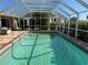 Inviting screened-in pool with deck and clear blue water, perfect for a refreshing swim at 285 Bal Harbor Blvd, Punta Gorda, FL 33950