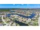 Aerial view shows a neighborhood with homes on canals, some featuring pools and docks, all leading to the ocean at 341 Segovia Dr, Punta Gorda, FL 33950