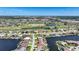 Aerial view of waterfront homes along deep water canals and overlooking a verdant green golf course at 341 Segovia Dr, Punta Gorda, FL 33950