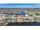High aerial view displays a coastal community with single-Gathering homes situated on canals leading to open water at 341 Segovia Dr, Punta Gorda, FL 33950