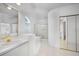 Bright bathroom featuring a soaking tub, shower with gold trim, and a double vanity with white cabinets and gold hardware at 341 Segovia Dr, Punta Gorda, FL 33950