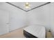 Bedroom with carpeted floor, a ceiling fan, and a doorway to the adjacent room at 341 Segovia Dr, Punta Gorda, FL 33950