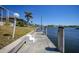Waterfront property features a private dock with boat lift access to the canal and open water at 341 Segovia Dr, Punta Gorda, FL 33950