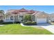 Charming single-story home with well-manicured lawn, tropical landscaping, and a striking red tile roof at 341 Segovia Dr, Punta Gorda, FL 33950