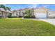Inviting single-story home featuring a well-manicured lawn and lush landscaping at 341 Segovia Dr, Punta Gorda, FL 33950