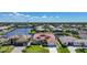 Inviting home features lush lawn, mature landscaping, a private driveway, and an attached two-car garage at 341 Segovia Dr, Punta Gorda, FL 33950