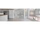 Kitchen with stainless steel fridge leading to breakfast nook, all with tile flooring at 341 Segovia Dr, Punta Gorda, FL 33950