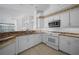 Bright kitchen featuring tiled floors and stainless steel appliances overlooking living area at 341 Segovia Dr, Punta Gorda, FL 33950