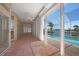 Covered lanai features brick flooring, ceiling fan, and views of the pool and serene canal at 341 Segovia Dr, Punta Gorda, FL 33950