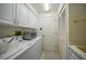 Functional laundry room with white cabinets, ample counter space, and a utility sink for added convenience at 341 Segovia Dr, Punta Gorda, FL 33950