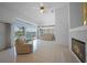 Spacious living room with fireplace, large windows overlooking the canal, and neutral decor throughout at 341 Segovia Dr, Punta Gorda, FL 33950