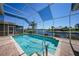 A screened-in pool offers a relaxing view of the waterfront and features a clear blue sky above at 341 Segovia Dr, Punta Gorda, FL 33950