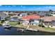 Elegant home features a private boat dock and swimming pool, with tropical foliage bordering the lanai at 341 Segovia Dr, Punta Gorda, FL 33950