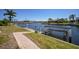 Brick pathway leading to a waterway with boat lifts and picturesque waterfront homes at 341 Segovia Dr, Punta Gorda, FL 33950