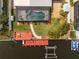 Aerial view featuring the pool, landscaped yard, dock, and boat lift at 4114 Yucatan Cir, Port Charlotte, FL 33948