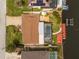 Aerial view of a home with pool, dock, and boat lift on a canal at 4114 Yucatan Cir, Port Charlotte, FL 33948