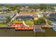 Home featuring a screened pool, landscaped yard, and dock with a boat lift at 4114 Yucatan Cir, Port Charlotte, FL 33948