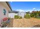 Cozy backyard featuring a decorative bench, palm trees, and a white storage shed at 4114 Yucatan Cir, Port Charlotte, FL 33948
