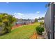 View of backyard on the water, featuring a dock with seating and grassy lawn at 4114 Yucatan Cir, Port Charlotte, FL 33948