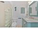 Bathroom with a vanity, toilet, and unique glass block shower at 4114 Yucatan Cir, Port Charlotte, FL 33948