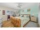 Cozy bedroom featuring a unique headboard, ceiling fan, and natural light from the window at 4114 Yucatan Cir, Port Charlotte, FL 33948