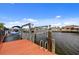 Waterfront home with private boat dock and lift, perfect for enjoying the sunny days on the water at 4114 Yucatan Cir, Port Charlotte, FL 33948