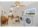 Combined laundry room and office area with a flower-style fan and a front load washer and dryer at 4114 Yucatan Cir, Port Charlotte, FL 33948