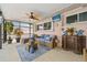 Covered patio space with a ceiling fan, outdoor furniture, plants, and a TV at 4114 Yucatan Cir, Port Charlotte, FL 33948