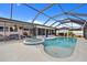Screened-in pool area with an attached hot tub and connecting patio at 4114 Yucatan Cir, Port Charlotte, FL 33948
