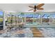 Enclosed sunroom featuring a view of the pool and waterfront canal at 4114 Yucatan Cir, Port Charlotte, FL 33948