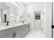 A spacious bathroom with double sinks, quartz countertop, and matte black hardware at 5110 Burri Ct, North Port, FL 34288