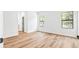Spacious bedroom with neutral walls, wood-look floors, and natural light from two windows at 5110 Burri Ct, North Port, FL 34288