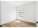 A bedroom with wood floors, neutral paint, and a single window at 5110 Burri Ct, North Port, FL 34288