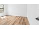 A bright, empty bedroom with luxury vinyl flooring, neutral walls, and a window at 5110 Burri Ct, North Port, FL 34288