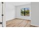 Bright, empty bedroom with natural light, wood floors, and a neutral color palette at 5110 Burri Ct, North Port, FL 34288