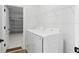Bright laundry room featuring a new washer and dryer next to the garage entry at 5110 Burri Ct, North Port, FL 34288