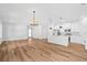 Open concept living and kitchen area featuring modern lighting, appliances, and wood flooring at 5110 Burri Ct, North Port, FL 34288