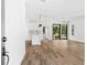 Bright and spacious living room features a kitchen, modern lighting, and sleek wood flooring at 5110 Burri Ct, North Port, FL 34288