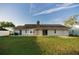 Spacious backyard with lush green grass, perfect for outdoor activities and relaxation with a brick chimney feature at 536 Lakehurst Nw Ave, Port Charlotte, FL 33952
