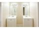 Bright bathroom with double sink vanities and updated mirrors at 536 Lakehurst Nw Ave, Port Charlotte, FL 33952