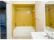 Well-maintained bathroom with a bathtub and shower featuring yellow tiling at 536 Lakehurst Nw Ave, Port Charlotte, FL 33952